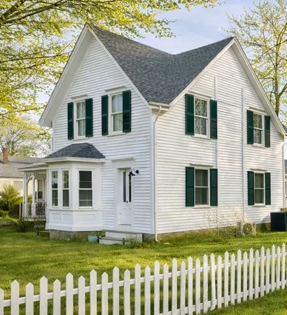 a front view of a house with a garden