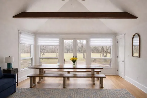 a living room with furniture and wooden floor
