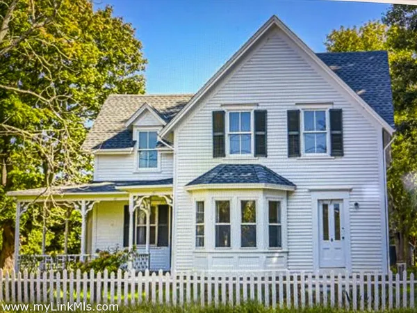 a view of a brick house with large windows