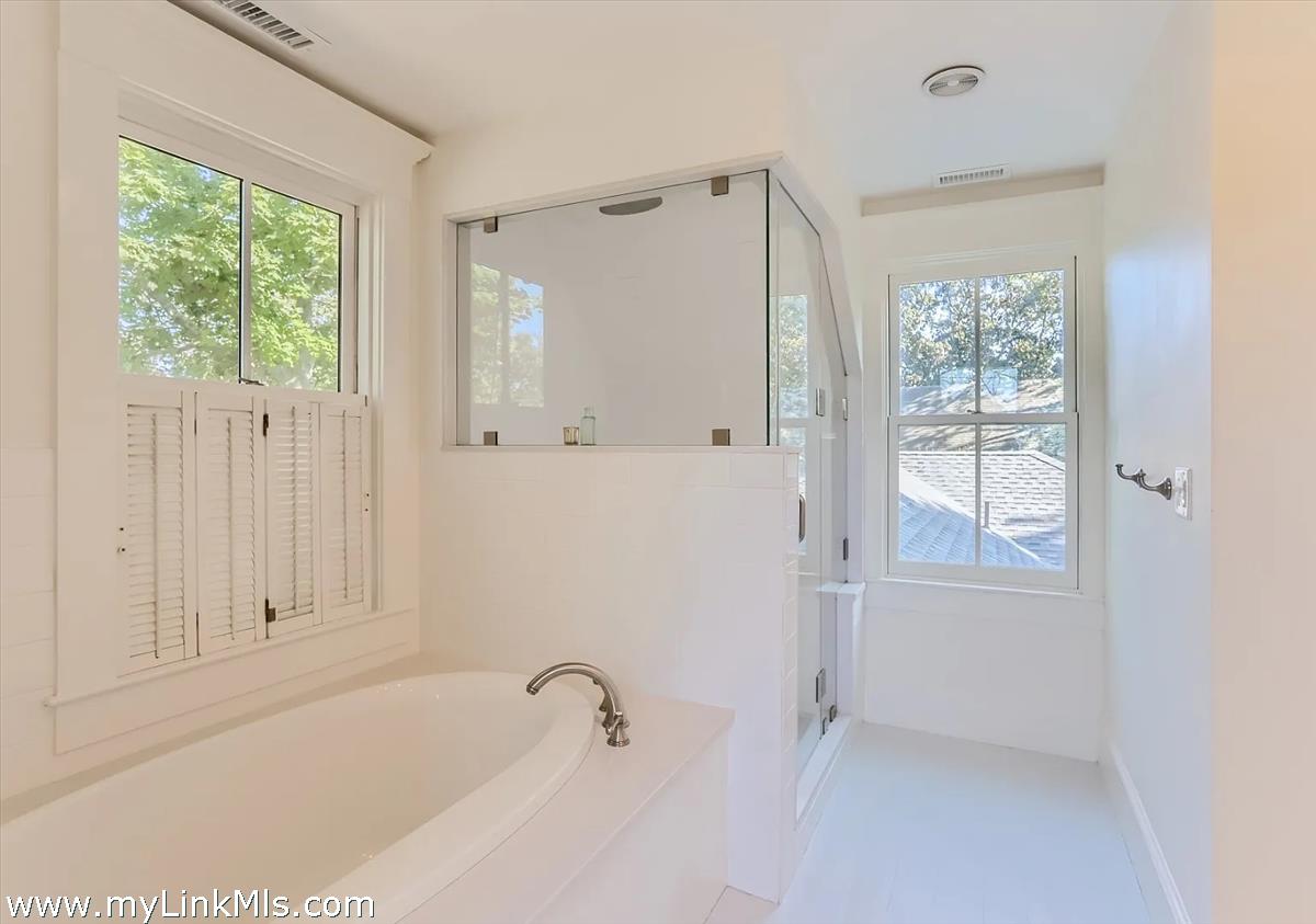 16 S Road Chilmark, MA 02535 - Photo 27 of 30 a bathroom with a tub shower and window
