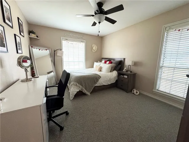 a bed room with a bed window and a chair