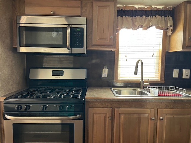 2795 East 28th Road Marseilles, IL 61341 - Photo 9 of 22 a kitchen with granite countertop a stove and a sink