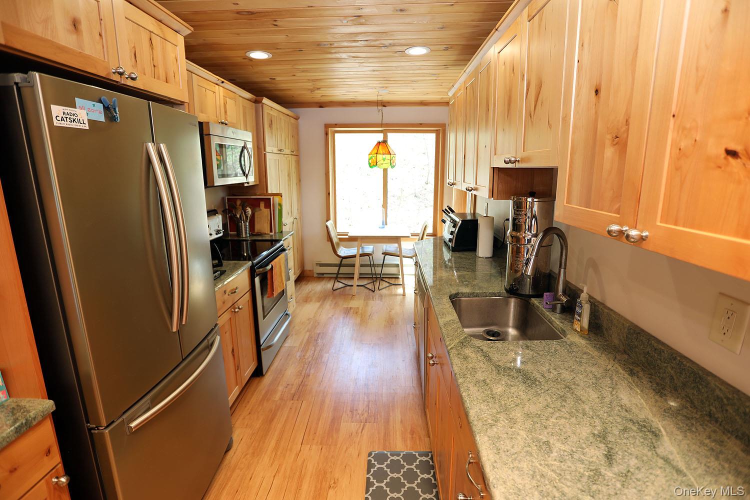 5120 Peas Eddy Road Hancock, NY 13783 - Photo 19 of 37 a view of a kitchen with furniture and a window