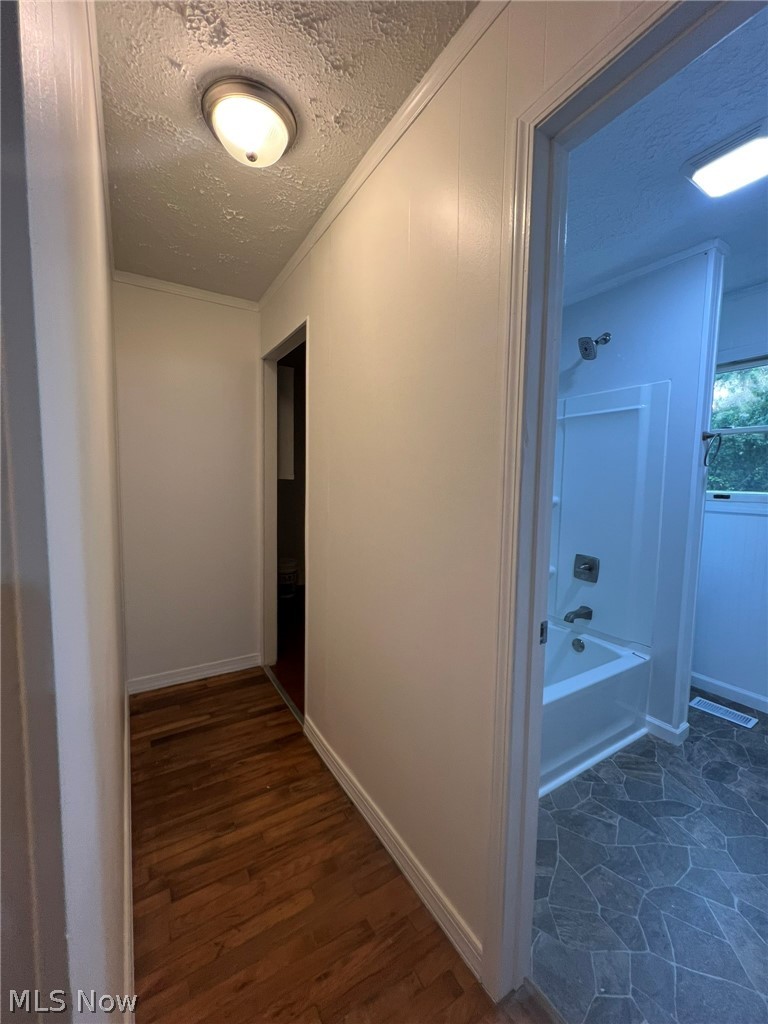 1105 Dutch Ridge Road Guysville, OH 45735 - Photo 16 of 33 Hallway featuring wood-finish flooring, white paneling, and a flush-mount ceiling light