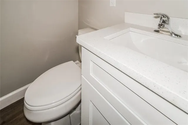 a close view of a sink and a toilet in bathroom