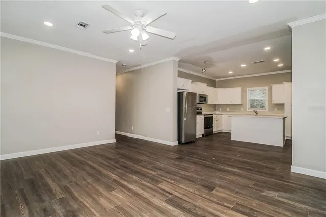 a view of a kitchen with wooden floor and a kitchen