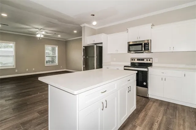 a kitchen that has a sink and a stove in it