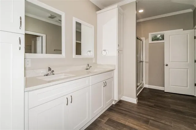 a bathroom with a double vanity sink and a mirror