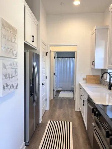 a kitchen with stainless steel appliances granite countertop a refrigerator and a sink
