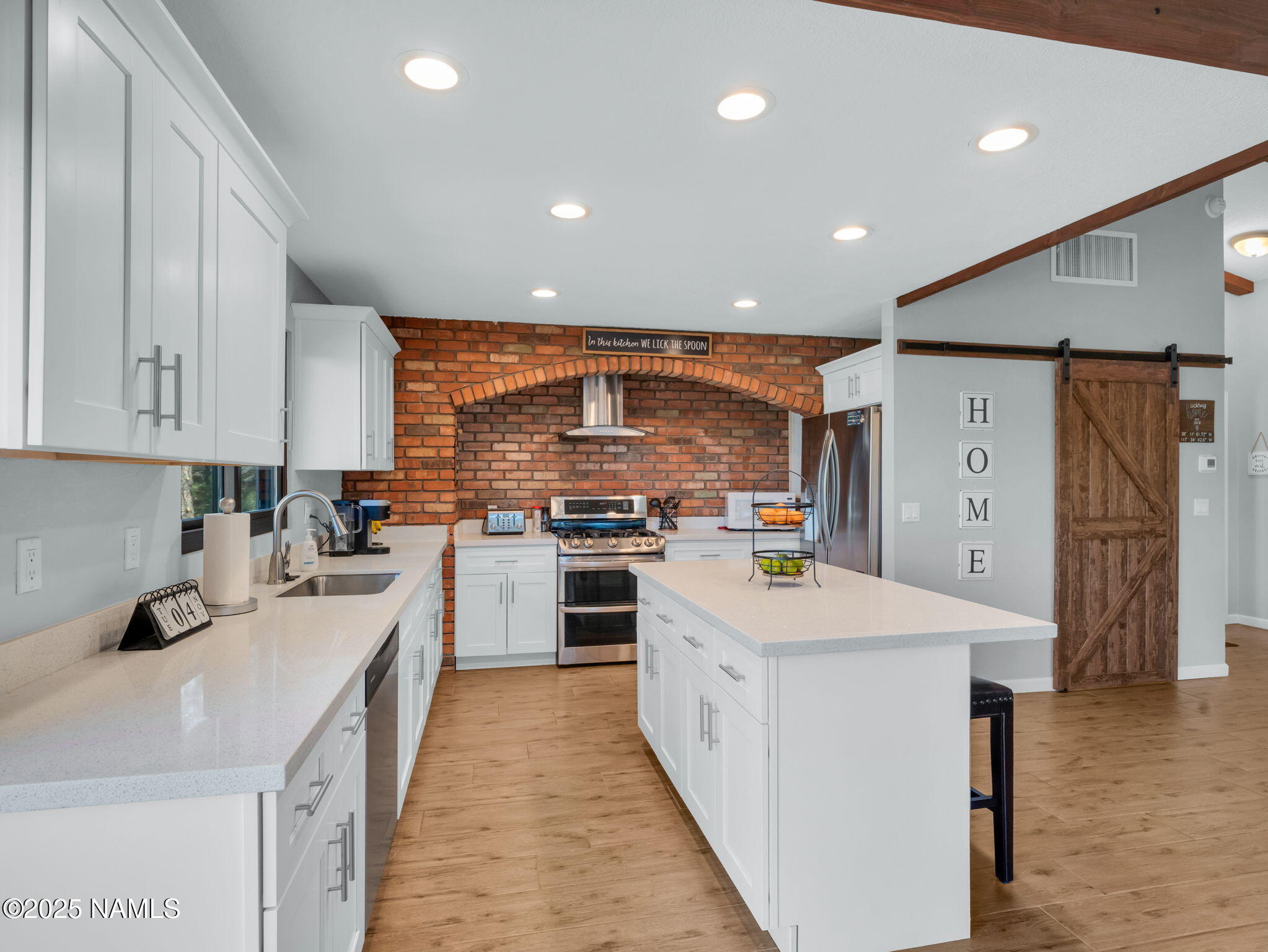 2201 North Fox Hill Road Flagstaff, AZ 86004 - Photo 13 of 38 a kitchen with white cabinets and stainless steel appliances