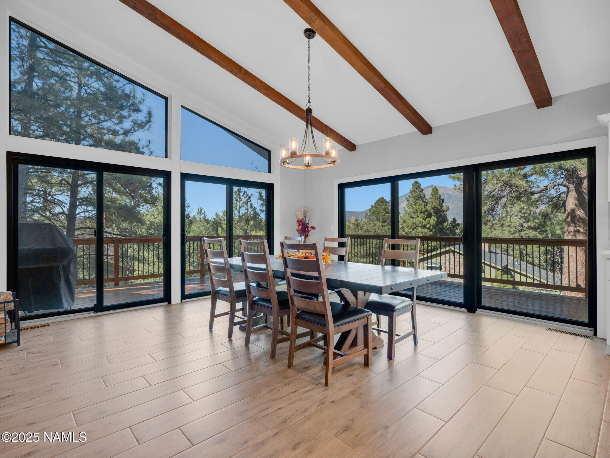 2201 North Fox Hill Road Flagstaff, AZ 86004 - Photo 15 of 38 a view of a dining room with furniture large windows and wooden floor