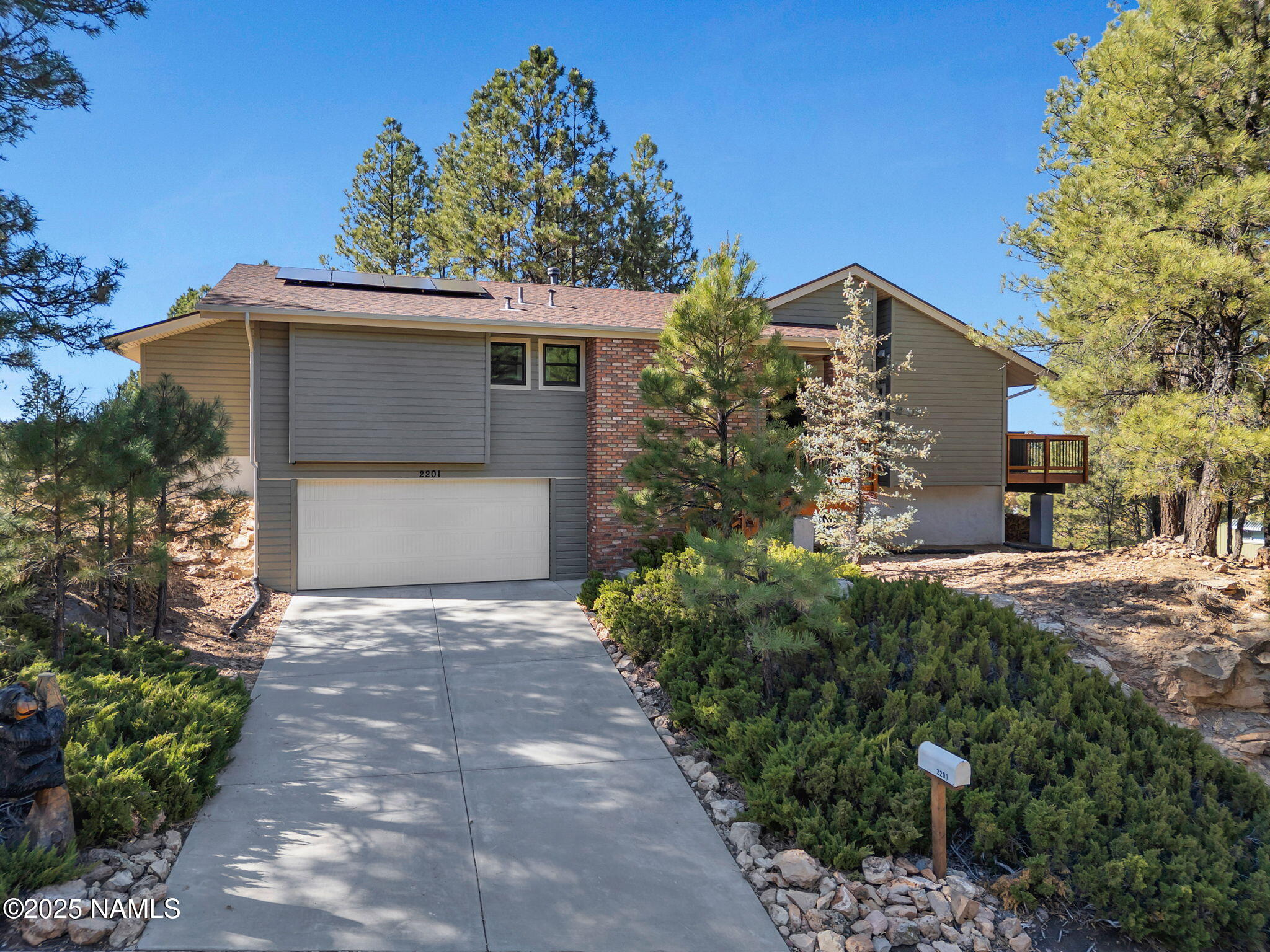 2201 North Fox Hill Road Flagstaff, AZ 86004 - Photo 3 of 38 a front view of a house with a yard and garage