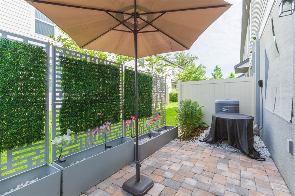 2760 Emory Sound Place Brandon, FL 33510 - Photo 11 of 52 a view of a table and chairs under an umbrella in the patio