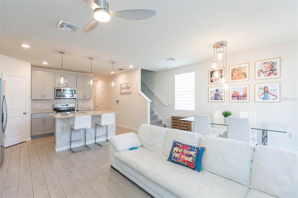 2760 Emory Sound Place Brandon, FL 33510 - Photo 20 of 52 a living room with kitchen island furniture and a kitchen view