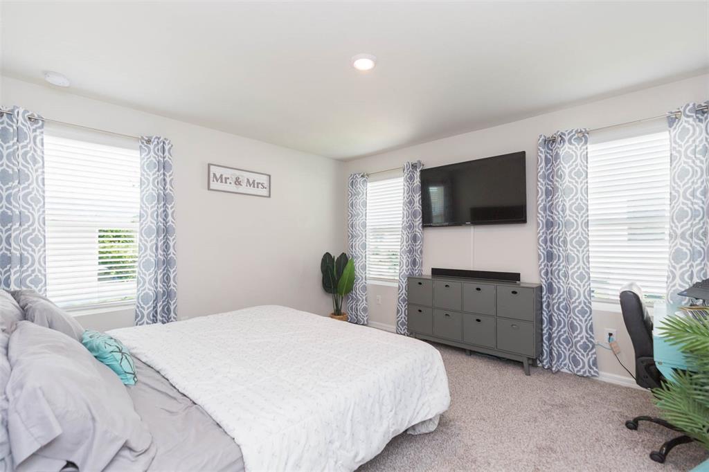 2760 Emory Sound Place Brandon, FL 33510 - Photo 42 of 52 a bedroom with a bed and a flat screen tv