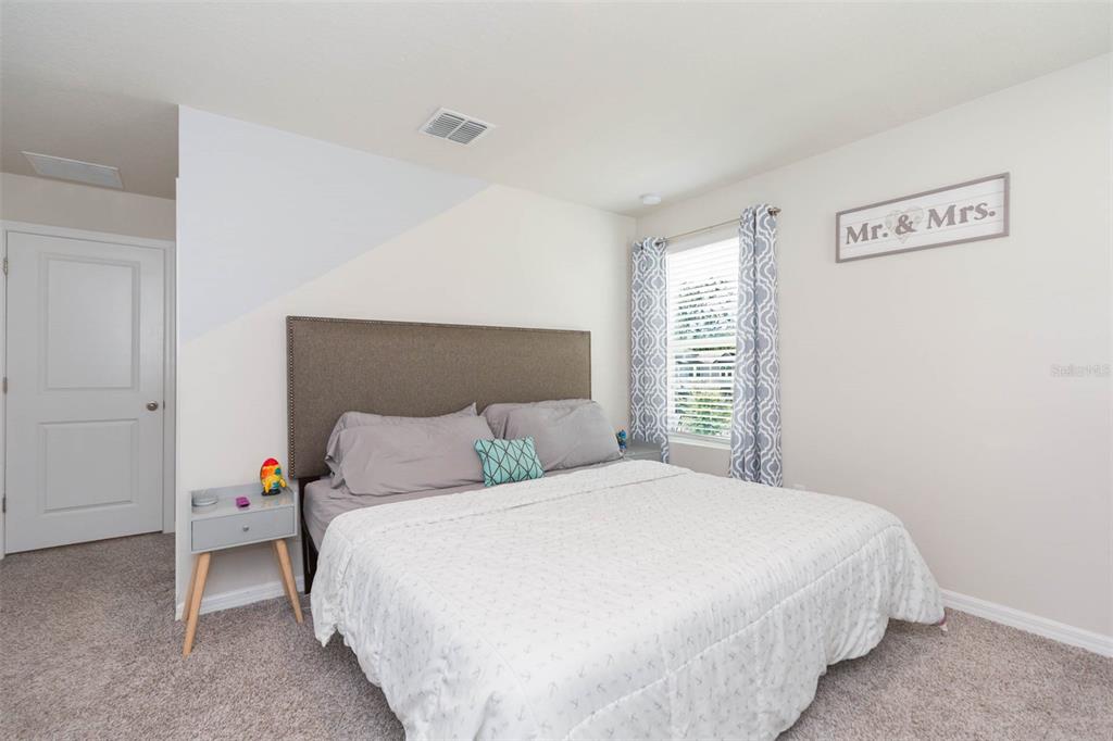 2760 Emory Sound Place Brandon, FL 33510 - Photo 43 of 52 a bedroom with a bed and a window