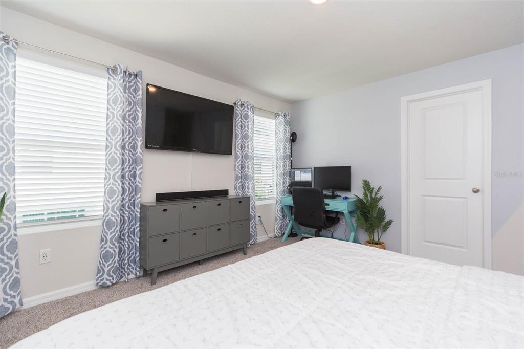 2760 Emory Sound Place Brandon, FL 33510 - Photo 45 of 52 a bedroom with a bed and a flat screen tv