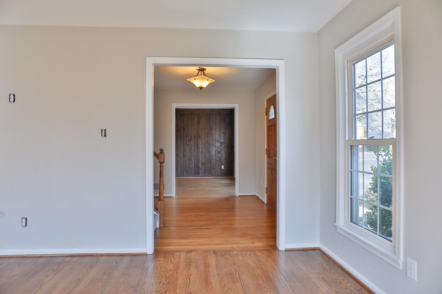 5423 Rilian Court Burke, VA 22015 - Photo 13 of 67 a view of a hallway with wooden floor and a living room