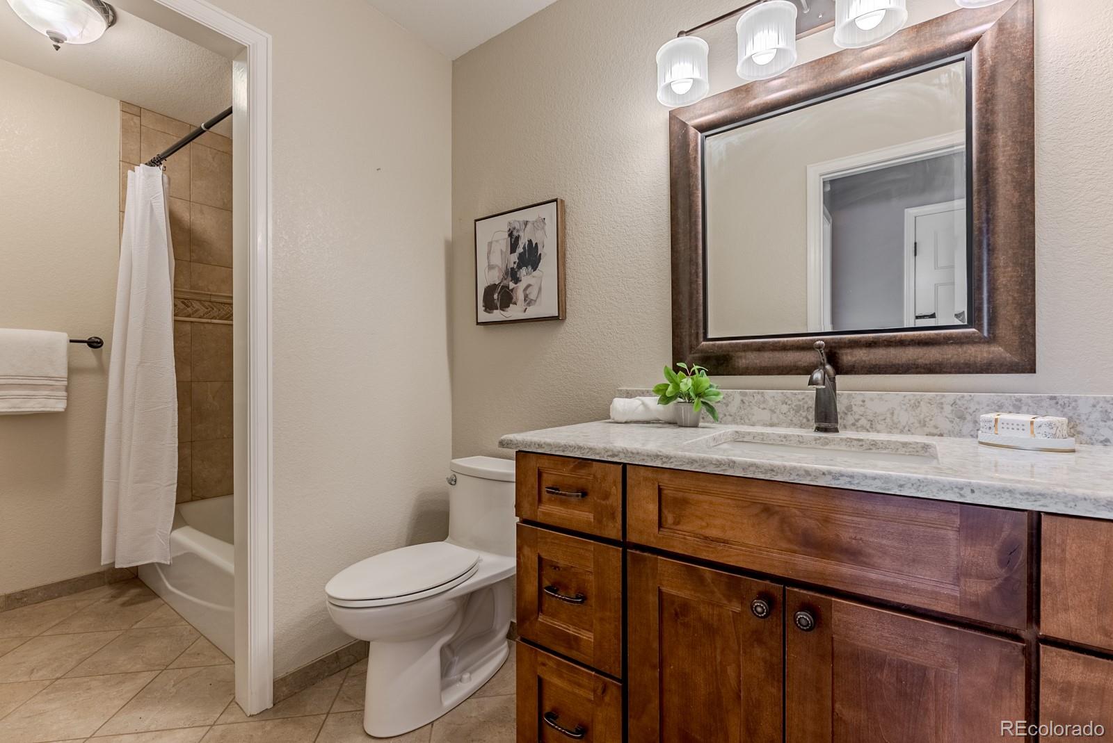 1914 Terrace Drive Highlands Ranch, CO 80126 - Photo 34 of 47 a bathroom with a toilet a sink and mirror