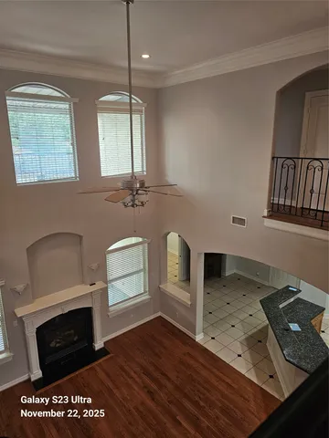 a kitchen with stainless steel appliances granite countertop a stove a sink and a microwave oven with white cabinets