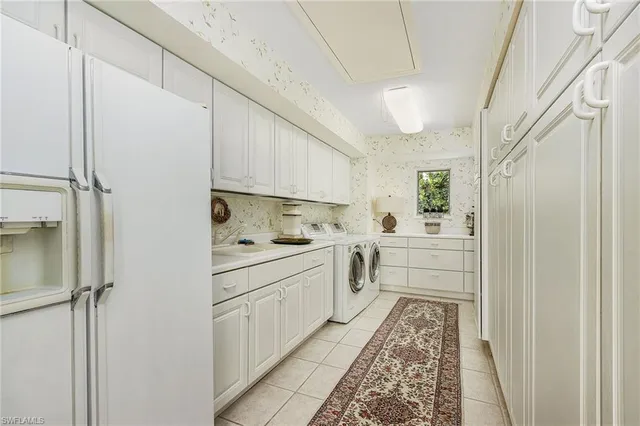 a kitchen with white cabinets and white appliances