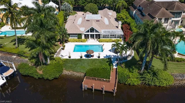 an aerial view of residential houses with outdoor space and trees