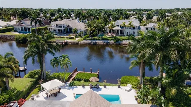 an aerial view of a house with outdoor space and lake view