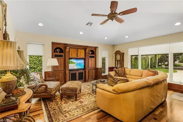 a living room with furniture ceiling fan and a window