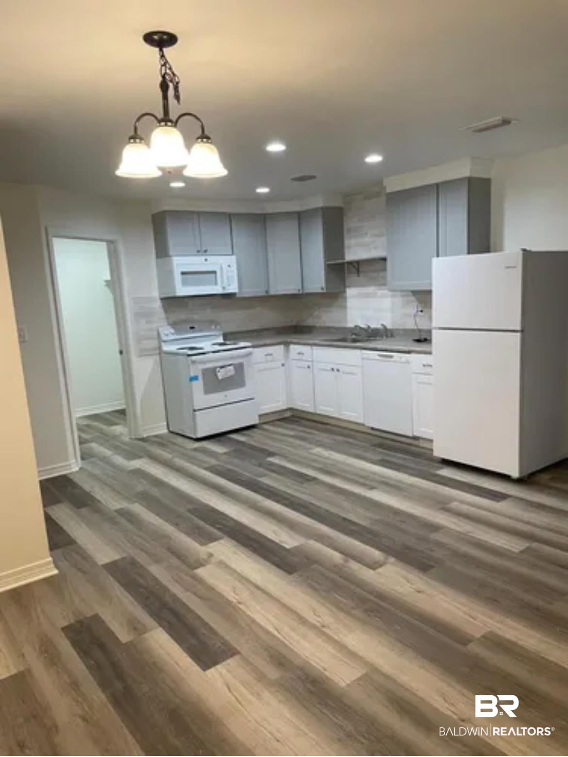 2 Canterberry Circle Foley, AL 36535 - Photo 22 of 24 Kitchen featuring white appliances, baseboards, dark wood-style floors, pendant lighting, and recessed lighting