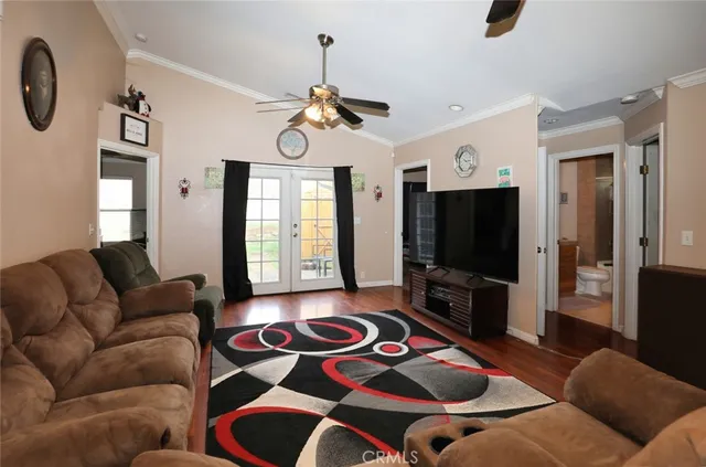 a living room with furniture a flat screen tv and a window