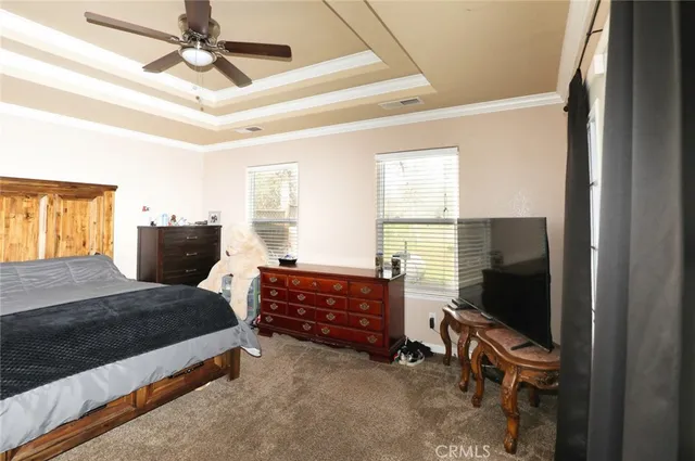 a bedroom with a bed and a flat tv screen