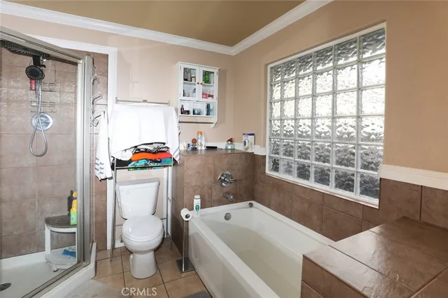 a bathroom with a granite countertop toilet a sink and a bathtub