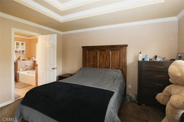 a bedroom with a bed and mirror