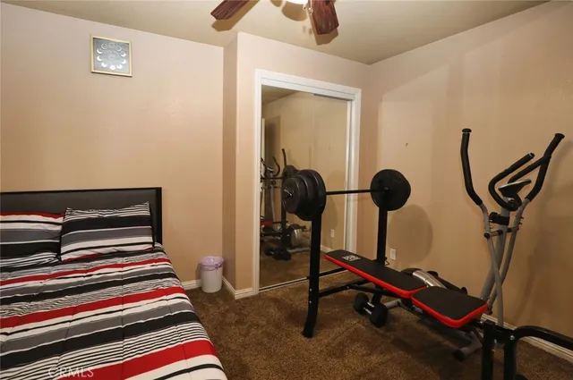 a bedroom with bed and gym equipment