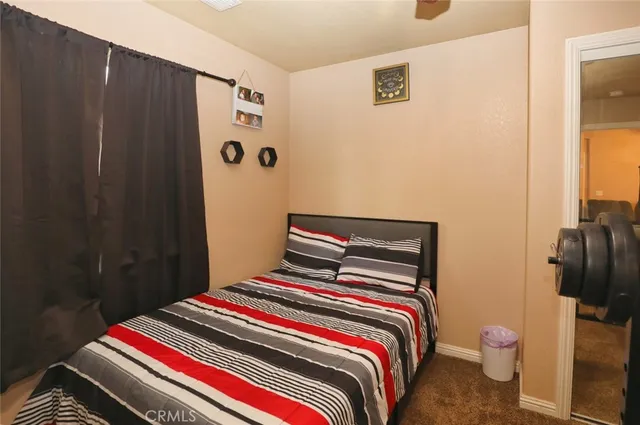 a bedroom with a bed and a mirror