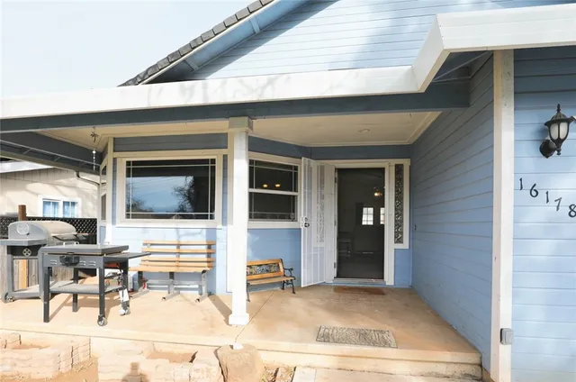 a view of living room filled with furniture and large window