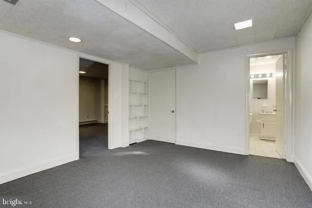 an empty room with closet and windows