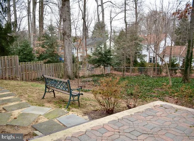 a view of a bench in the backyard