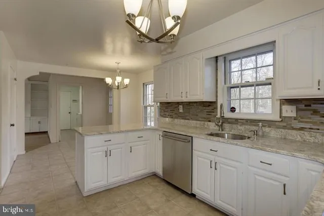 a kitchen with a sink cabinets and window