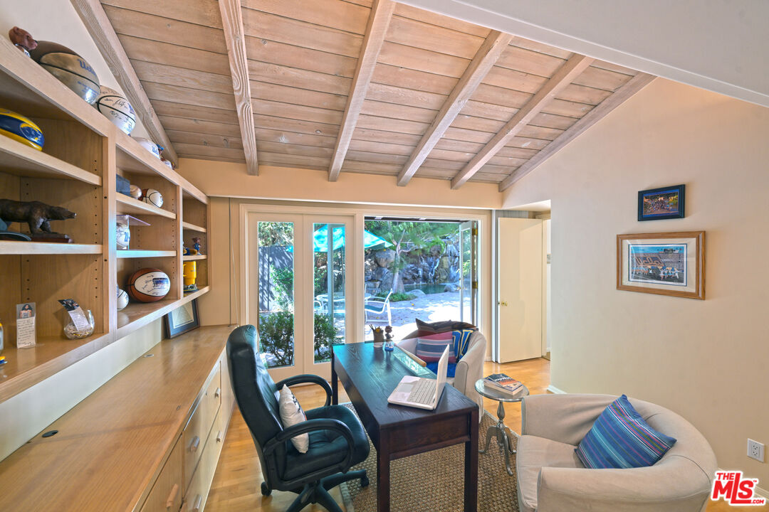 601 Tuallitan Road Los Angeles, CA 90049 - Photo 11 of 23 a living room with furniture and a floor to ceiling window