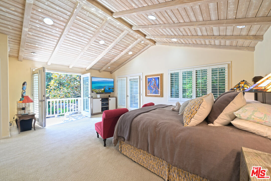 601 Tuallitan Road Los Angeles, CA 90049 - Photo 16 of 23 a bedroom with a bed and a large window