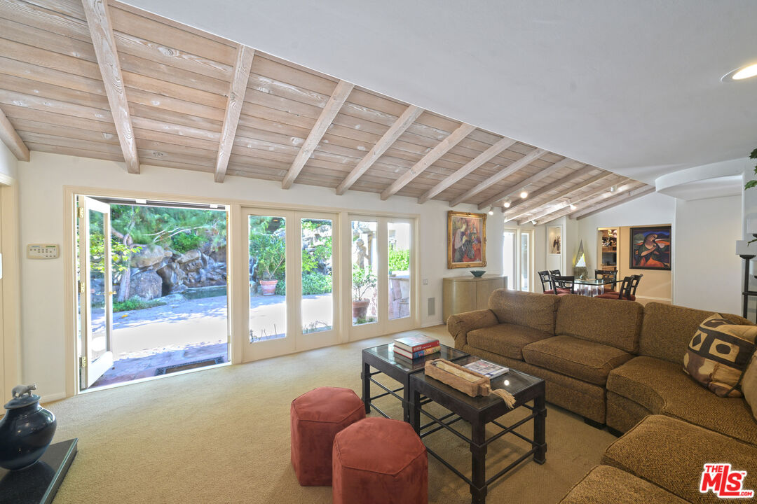 601 Tuallitan Road Los Angeles, CA 90049 - Photo 5 of 23 a living room with furniture and a floor to ceiling window
