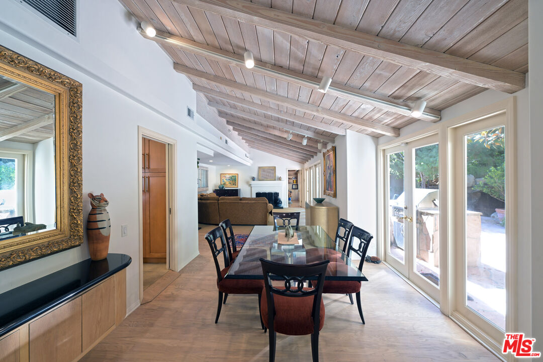 601 Tuallitan Road Los Angeles, CA 90049 - Photo 6 of 23 a view of a dining room with furniture window and wooden floor