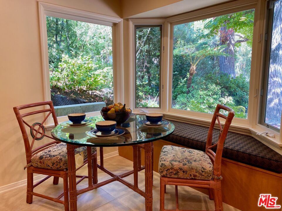 601 Tuallitan Road Los Angeles, CA 90049 - Photo 9 of 23 a view of a dining room with furniture and window