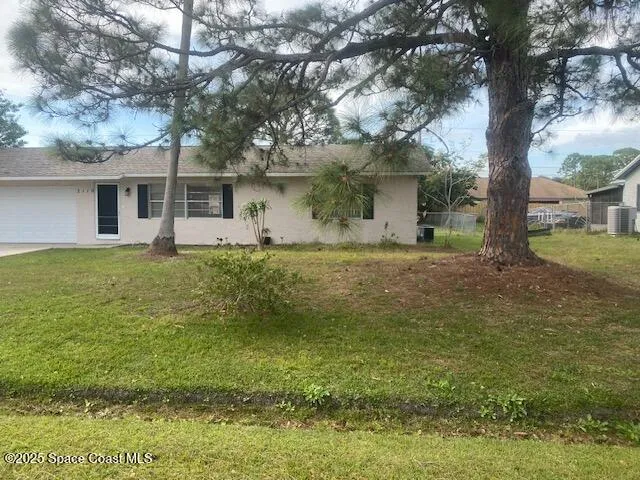 a house that has a tree in front of it