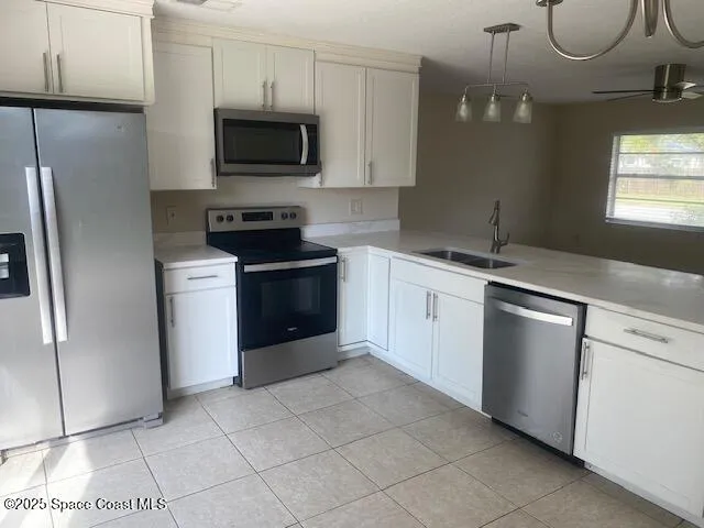 a kitchen with cabinets stainless steel appliances and a sink