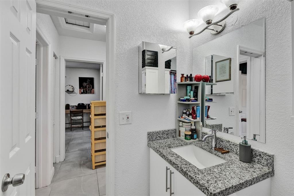 220 Northeast 165th Street Miami, FL 33162 - Photo 11 of 26 a bathroom with a sink vanity and mirror