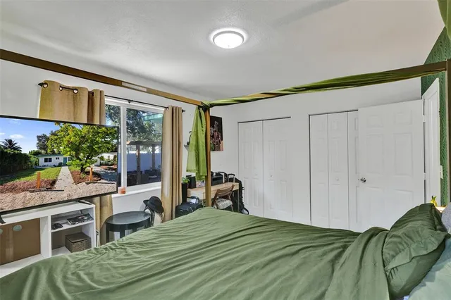 a bed room with a bed and a chair