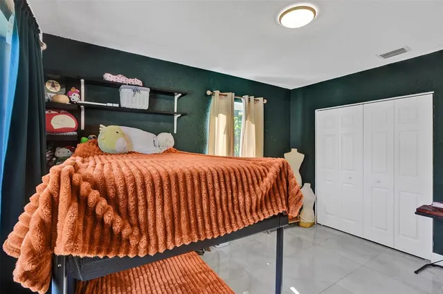 a bedroom with a bed and window