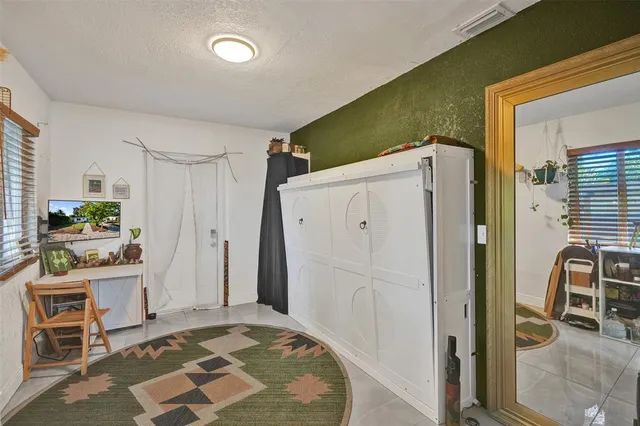 a view of kitchen with furniture and refrigerator